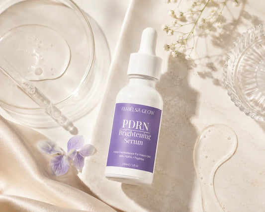 FEMELSA Glow PDRN Brightening Serum displayed in a luxury skincare flat lay with serum textures, glass dropper, soft beige tones, and clean Korean skincare aesthetic.